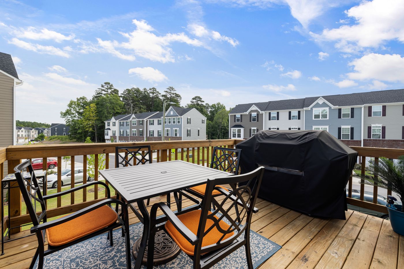 Elevated wooden deck with dining set and balustrade